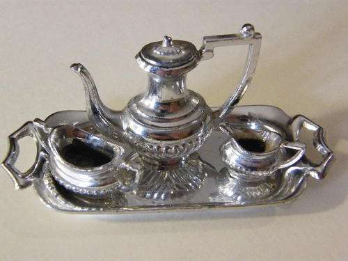 Small tray with small teapot(with lid), cream jug and sugar bowl - mark on tray is a swan with a T