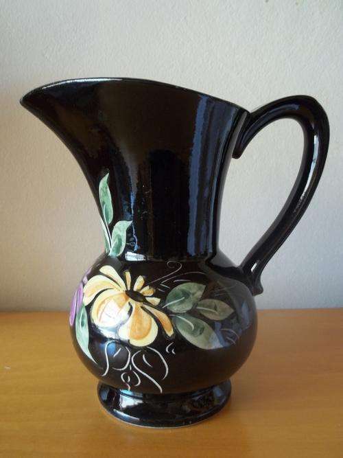 Black pitcher with flower detail