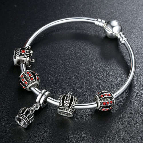 Silver plated, solid bracelet, 17cm; with 5 Royalty charms