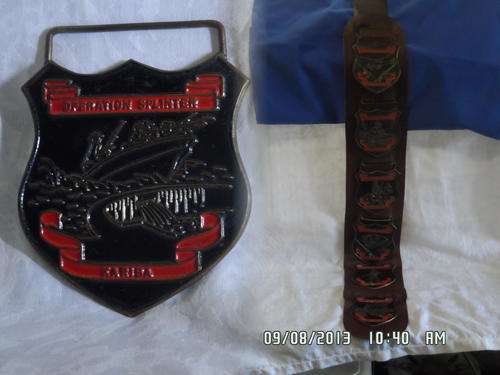 X6 RHODESIAN MILITARY OPERATIONS METAL BADGES ON A LEATHER STRIP