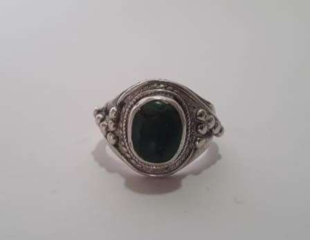 A fabulously decorated, solid sterling silver ring size M. Set with a cabochon green gem stone.