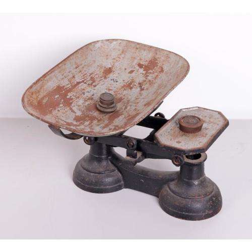 Vintage cast iron balance scale with original bowl and five weights