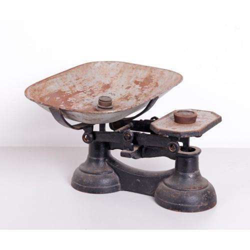 Vintage cast iron balance scale with original bowl and five weights