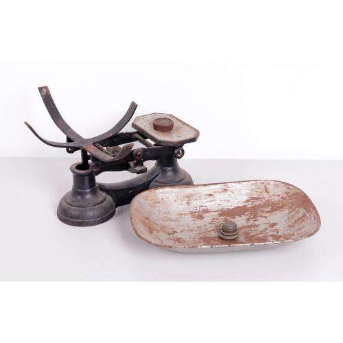 Vintage cast iron balance scale with original bowl and five weights