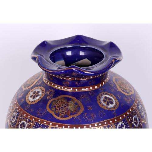 Large Japanese blue-ground vase decorated with floral panels and rondels