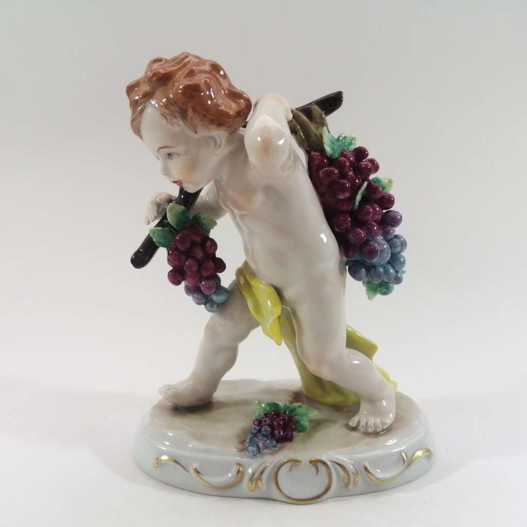 German Sitzendorf Figurine Depicting a Putto Carrying Grapes