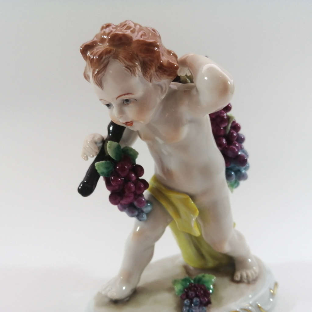 German Sitzendorf Figurine Depicting a Putto Carrying Grapes