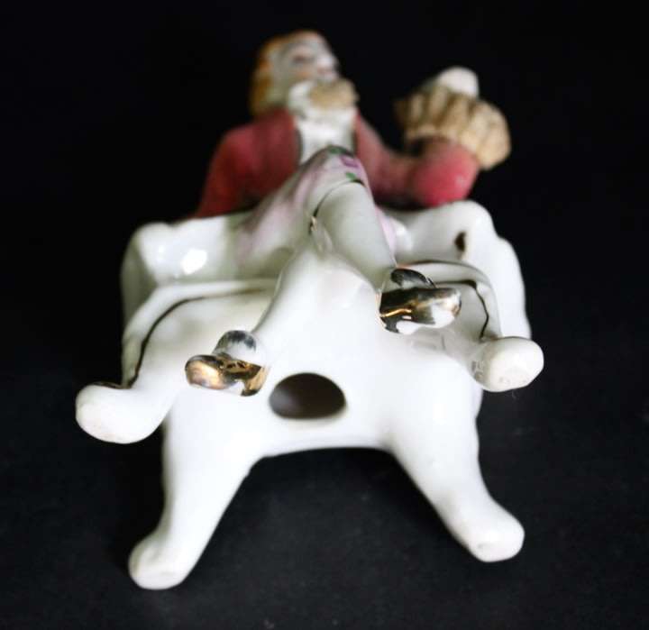 Porcelain Figurine of Man on Seat.