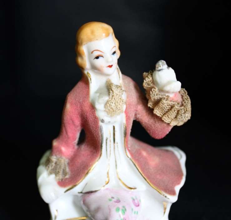 Porcelain Figurine of Man on Seat.