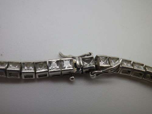 Sterling Silver tennis bracelet set with princess cut cubic zirconias. 20 cm 20.3 grms