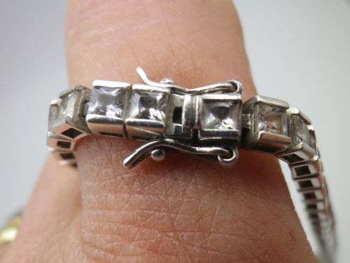 Sterling Silver tennis bracelet set with princess cut cubic zirconias. 20 cm 20.3 grms