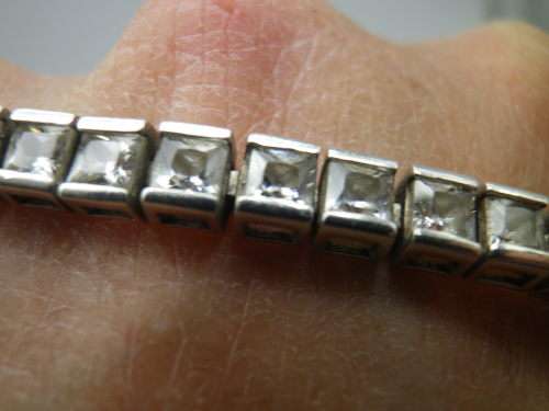 Sterling Silver tennis bracelet set with princess cut cubic zirconias. 20 cm 20.3 grms