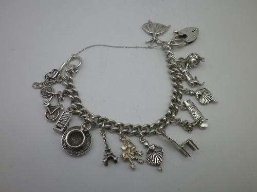 Sterling Silver Vintage Charm bracelet. Hallmarked clasp. Heavy Rare charm. 72grms Excellent quality