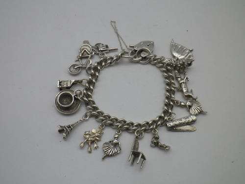 Sterling Silver Vintage Charm bracelet. Hallmarked clasp. Heavy Rare charm. 72grms Excellent quality
