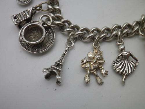 Sterling Silver Vintage Charm bracelet. Hallmarked clasp. Heavy Rare charm. 72grms Excellent quality