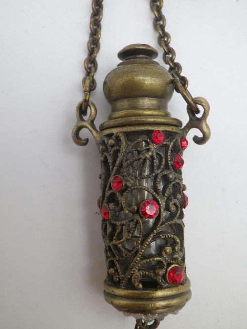 PERFUME BOTTLE PENDANT. Bronze tone metal with red glass beads. Intact. FAB!!!