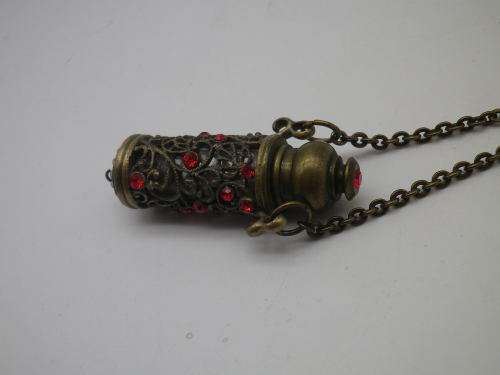 PERFUME BOTTLE PENDANT. Bronze tone metal with red glass beads. Intact. FAB!!!