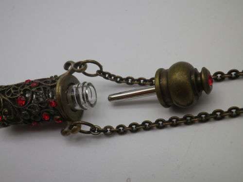 PERFUME BOTTLE PENDANT. Bronze tone metal with red glass beads. Intact. FAB!!!