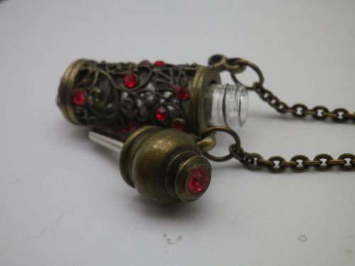 PERFUME BOTTLE PENDANT. Bronze tone metal with red glass beads. Intact. FAB!!!
