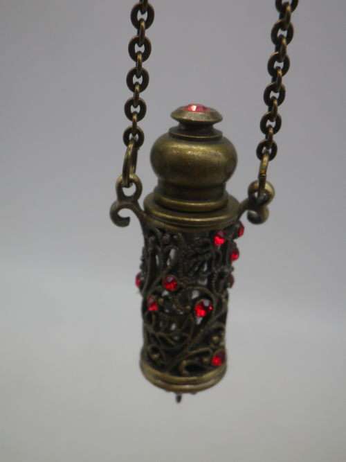 PERFUME BOTTLE PENDANT. Bronze tone metal with red glass beads. Intact. FAB!!!