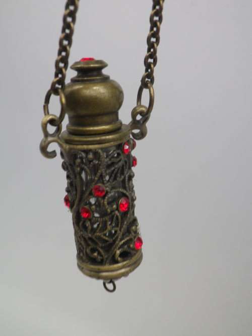 PERFUME BOTTLE PENDANT. Bronze tone metal with red glass beads. Intact. FAB!!!