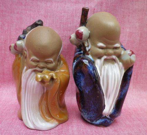 Kitsch & friendly. Pair of feel-good, unusual glazed pottery auspicious oriental sage figurines