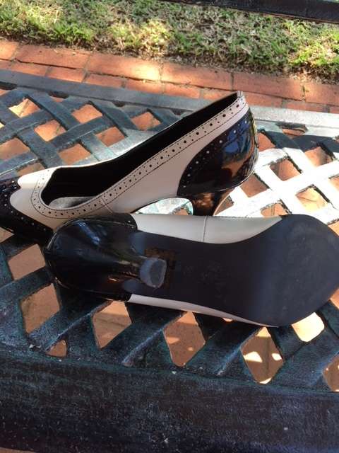 Black and white brogue heels