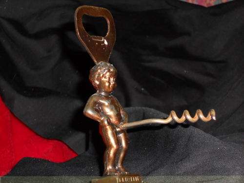 Brass bottle opener and cork screw. Little boy whee statue