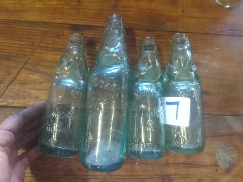 4 antique bottles with marbles