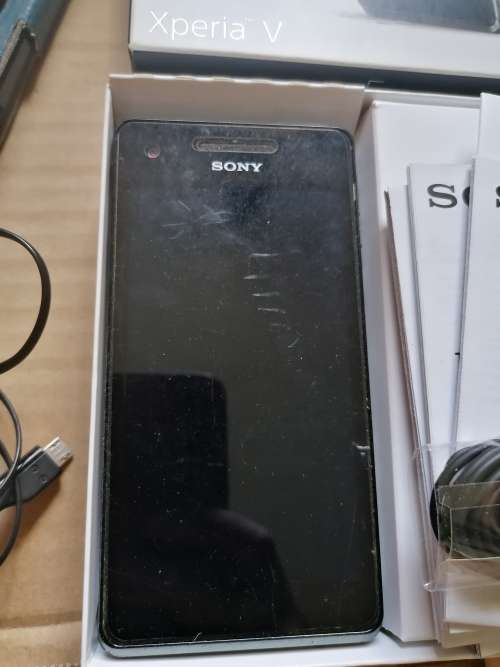 Sony Xperia v cell phone with charger, earphones, box and manuals. Working