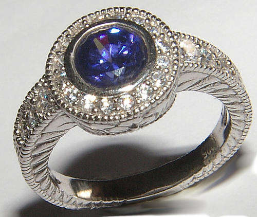DESIGNER TANZANITE AND DIAMOND SIMULANT STERLING SILVER RING.