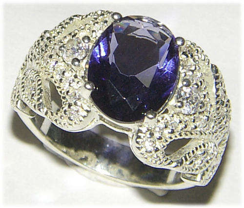 TANZANITE AND CZ STERLING SILVER RHODIUM PLATED RING.