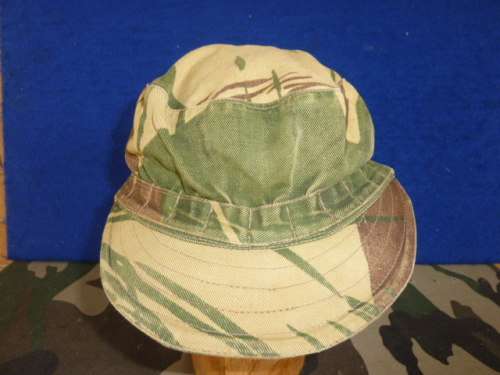 1) RHODESIAN (BRUSHSTROKE) CAMO -FLAPCAP-IN GOOD USED CONDITION-SIZE APPROX 57-NAMED-LOW START!