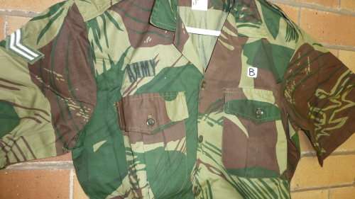 7B) A RHODESIAN SHORT SLEEVE-CAMO(BRUSHSTROKE) SHIRT WITH CORPORAL STRIPES & ARMY LABEL-NEVER WORN.