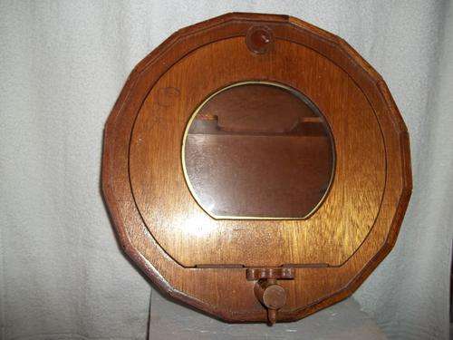 Wall mountable drink cabinet in the shape of a barrel made of wood