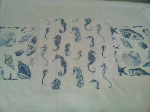 Small tablecloth with four napkins/ place mats. Printed blue on white cotton material.