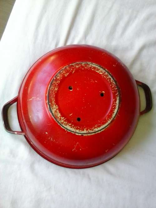 Enamel dish that was used as a flower pot. It has three holes in the bottom.