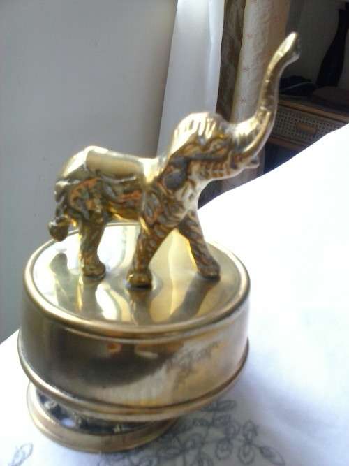 Small solid brass elephant on rotating musical stand, plays 'Tomorrow' from the movie Annie