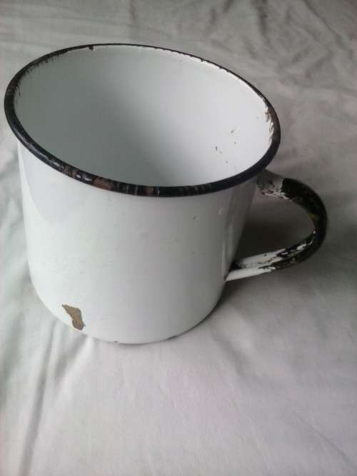 Large enamel jug, slightly damaged, white with black trim, 14.5cm high x 16cm diameter