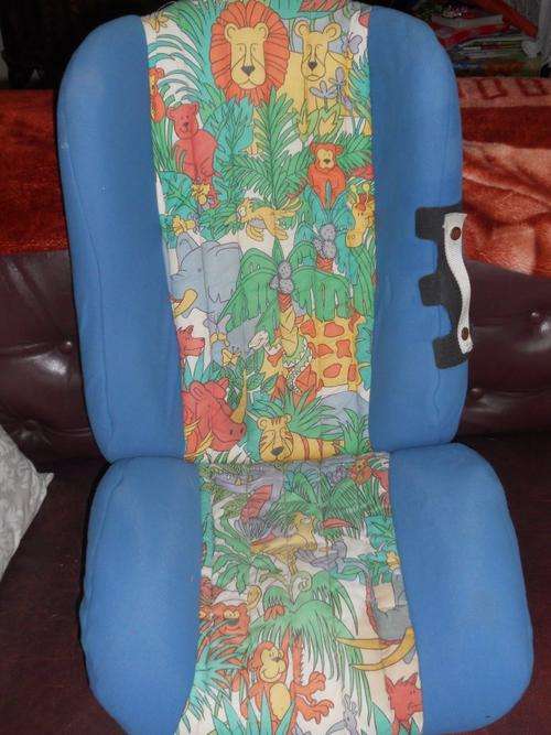 ASTI BOOSTER CAR SEAT with animal print covers,  suitable for a child from 8 months to 5 years