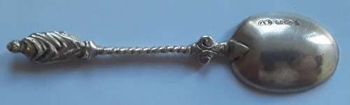 An antique solid silver spoon with figural finial. Arthur Graf, London, 1911.