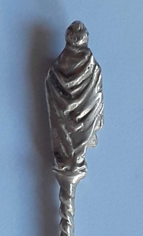 An antique solid silver spoon with figural finial. Arthur Graf, London, 1911.