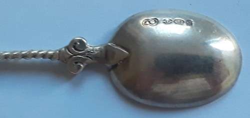 An antique solid silver spoon with figural finial. Arthur Graf, London, 1911.