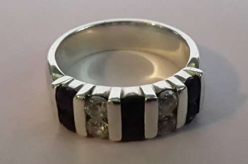 Lovely solid sterling silver ring with clear and purple stones.