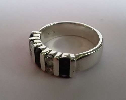 Lovely solid sterling silver ring with clear and purple stones.