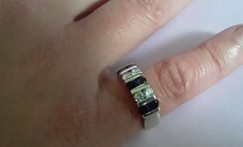 Lovely solid sterling silver ring with clear and purple stones.