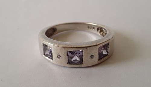 Solid sterling silver band ring with flush set purple stones. Size: N (17mm)