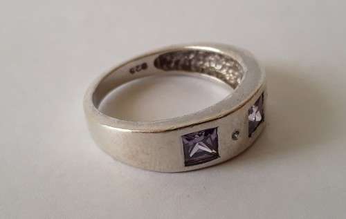 Solid sterling silver band ring with flush set purple stones. Size: N (17mm)