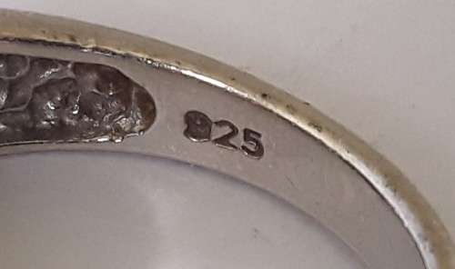 Solid sterling silver band ring with flush set purple stones. Size: N (17mm)