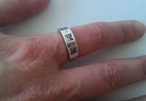 Solid sterling silver band ring with flush set purple stones. Size: N (17mm)